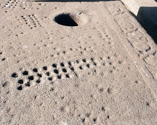 Gebeta (Mancala) holes from the Late Antiquity or early Medieval period in Aksum, Ethiopia. From the English Wikipedia article Mancala.